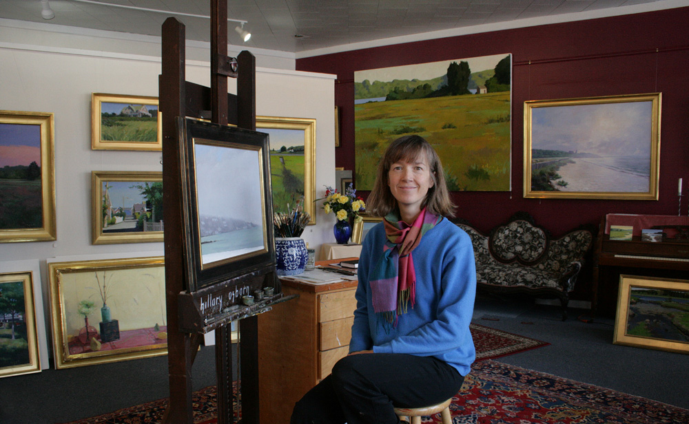 Hillary Osborn at the easel in the Osborn & Rugh Gallery.